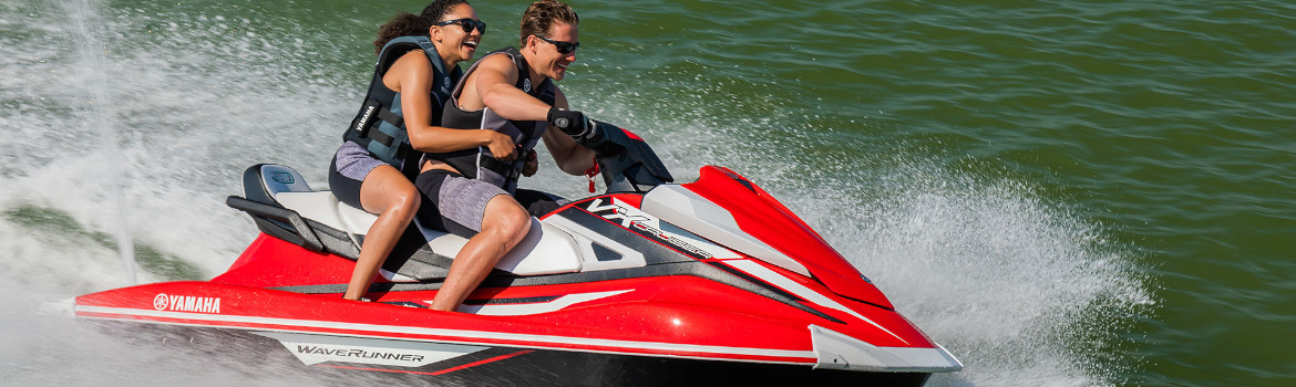 Two people having fun on a Yamaha WaveRunner® PWC on open water