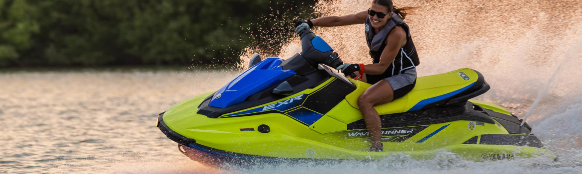 Woman riding a yellow Yamaha WaveRunner® on open water